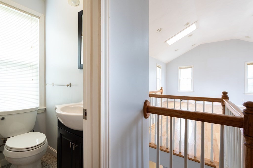 28 Stebbins Street Worcester, MA 01607 - Photo 17 of 29 a bathroom with a toilet a sink and a mirror