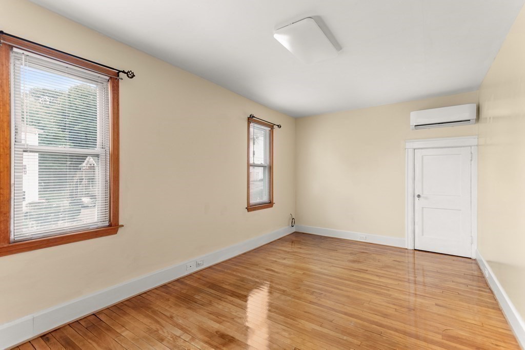 28 Stebbins Street Worcester, MA 01607 - Photo 19 of 29 a view of an empty room with wooden floor and a window