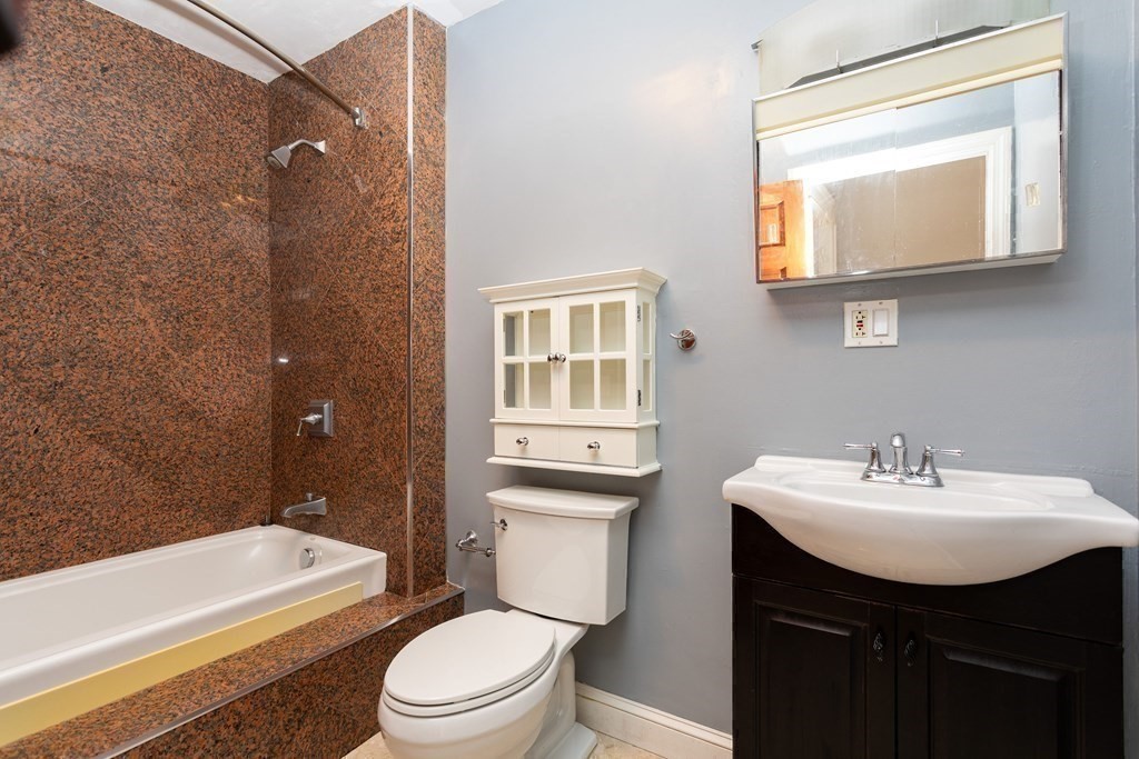 28 Stebbins Street Worcester, MA 01607 - Photo 24 of 29 a bathroom with a sink a toilet and shower