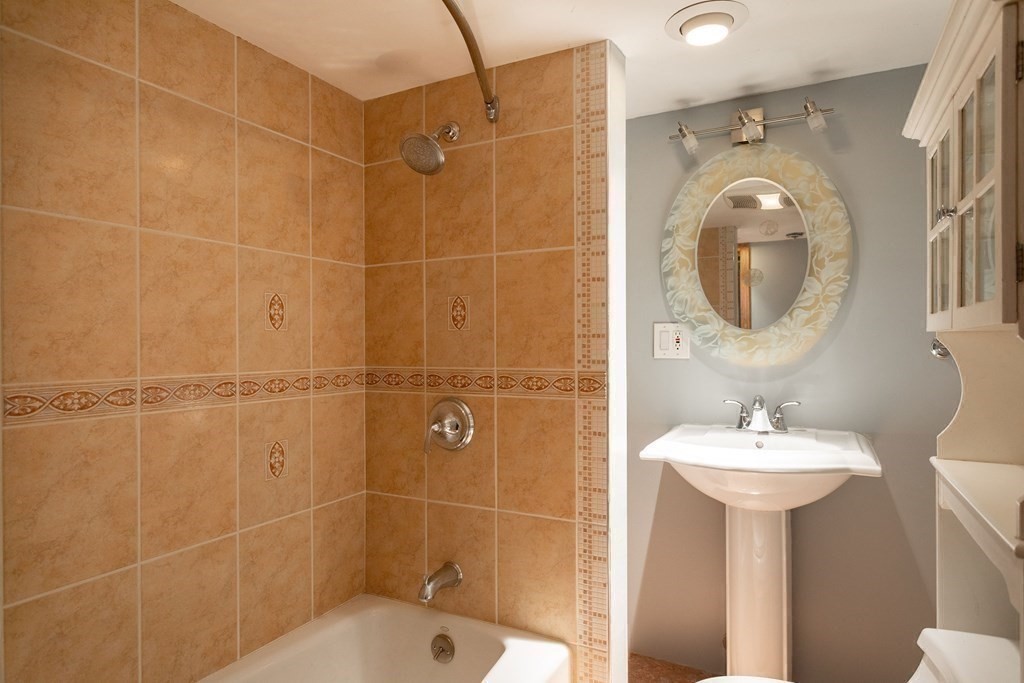 28 Stebbins Street Worcester, MA 01607 - Photo 26 of 29 a bathroom with a sink a mirror and a shower