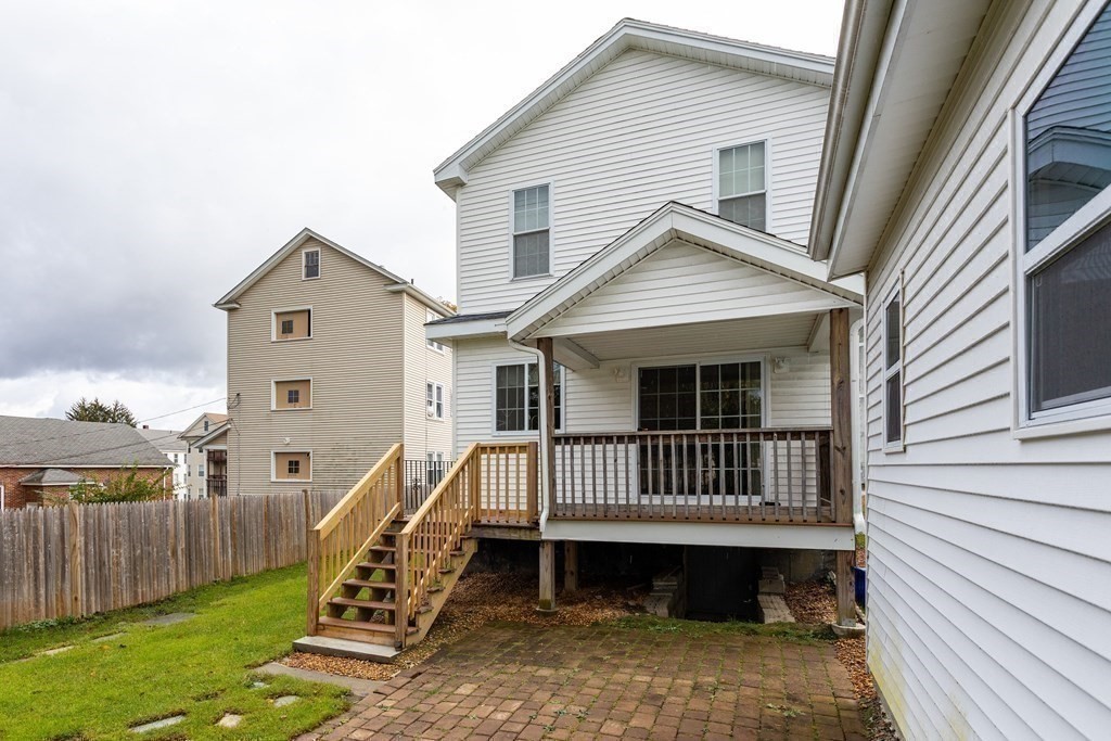 28 Stebbins Street Worcester, MA 01607 - Photo 28 of 29 a view of a house with a wooden deck and furniture