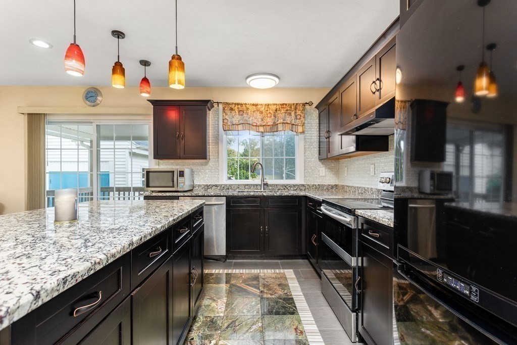 28 Stebbins Street Worcester, MA 01607 - Photo 3 of 29 a kitchen with granite countertop lots of counter top space appliances and a window