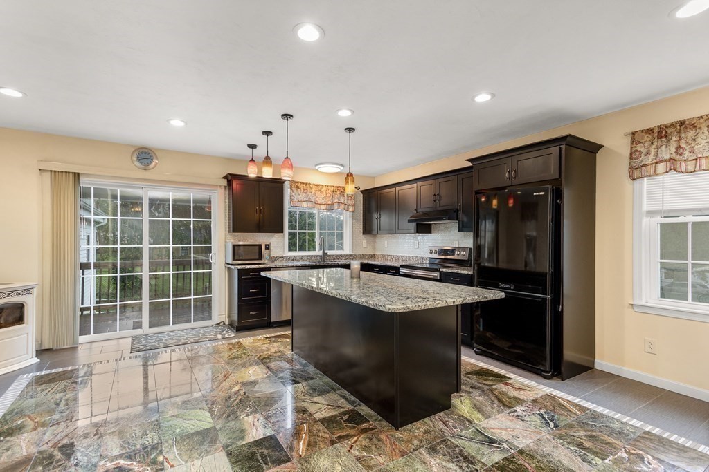 28 Stebbins Street Worcester, MA 01607 - Photo 4 of 29 a kitchen with stainless steel appliances granite countertop a sink stove and refrigerator