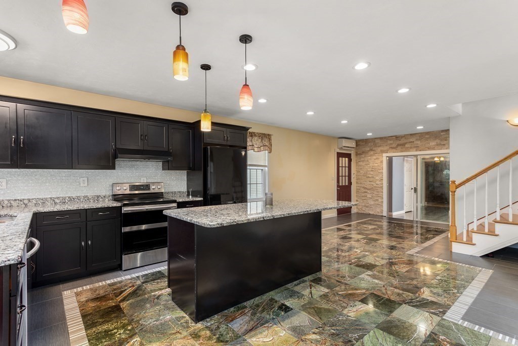 28 Stebbins Street Worcester, MA 01607 - Photo 5 of 29 a kitchen with stainless steel appliances granite countertop a stove a sink a refrigerator and a microwave