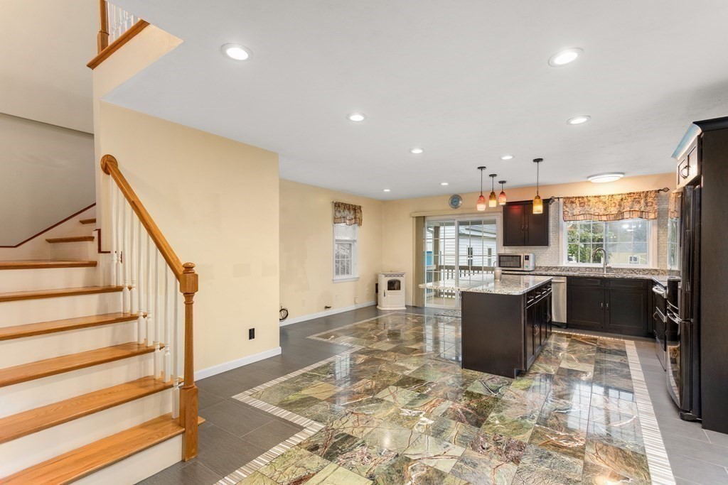 28 Stebbins Street Worcester, MA 01607 - Photo 8 of 29 a view of kitchen with granite countertop refrigerator and wooden cabinets