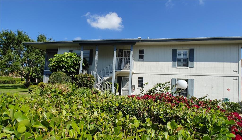 3300 Binnacle Drive, Unit 206 Naples, FL 34103 - Photo 3 of 11 front view of a house with a big yard