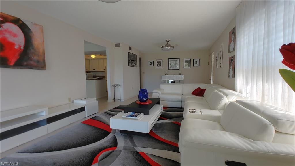 3300 Binnacle Drive, Unit 206 Naples, FL 34103 - Photo 6 of 11 a living room with furniture and a couch