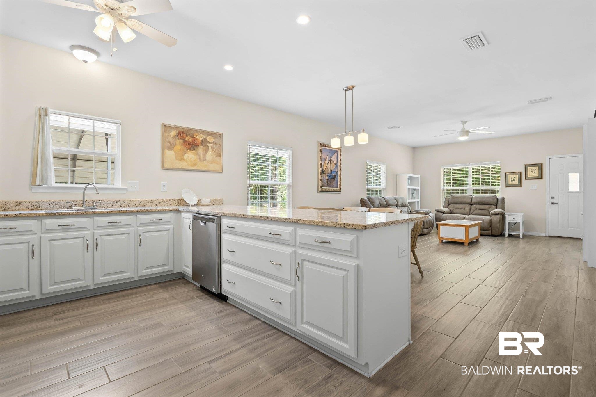 13751 Fish River Acres Circle Foley, AL 36535 - Photo 9 of 26 Kitchen with wood-finish flooring, white cabinetry, granite countertops, and a stainless steel dishwasher