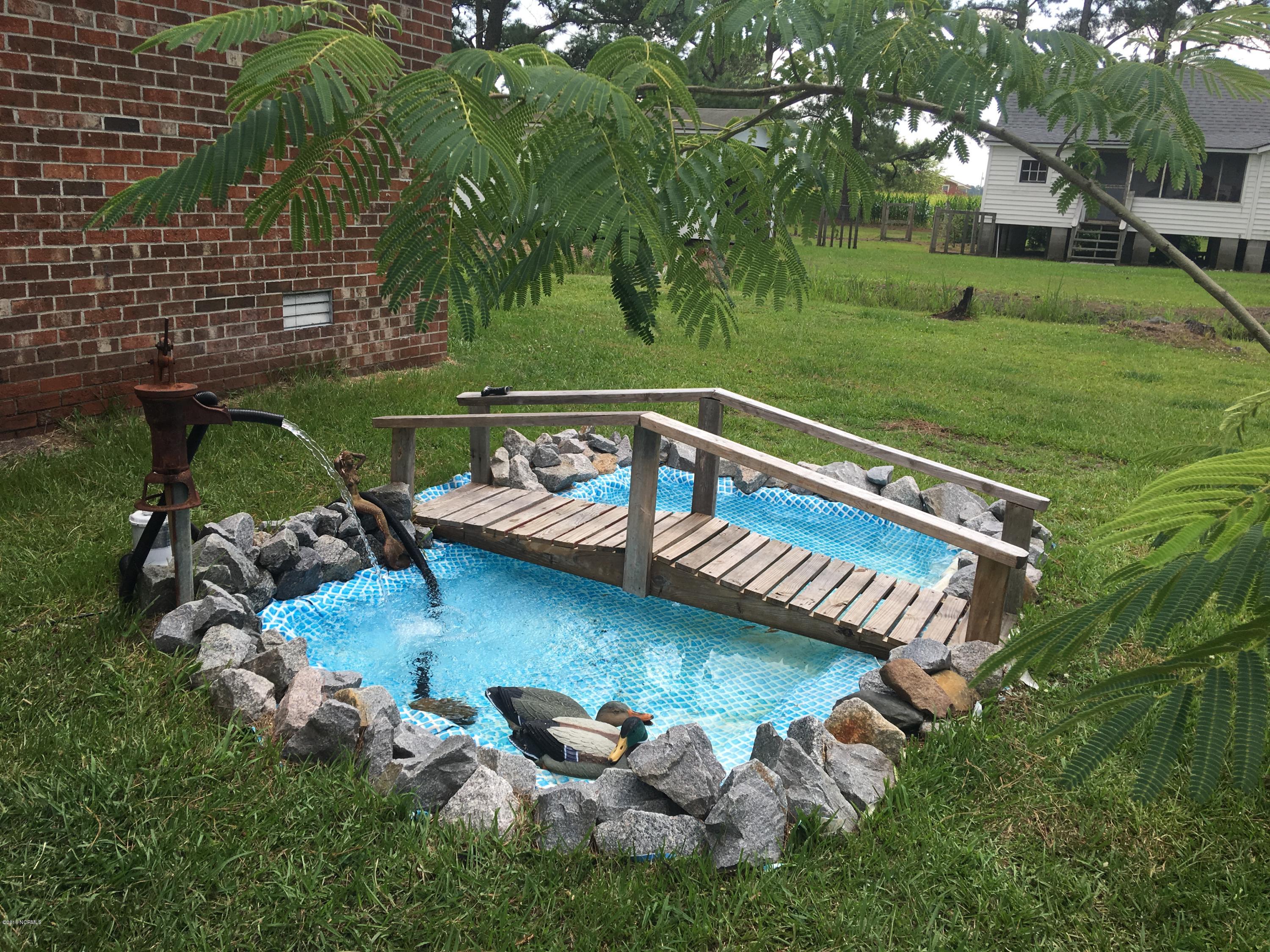 2165 Quarter Road Swanquarter, NC 27885 - Photo 5 of 16 Charming water feature that even includes the goldfish! Enjoy the sound of splashing water on those hot summer days.