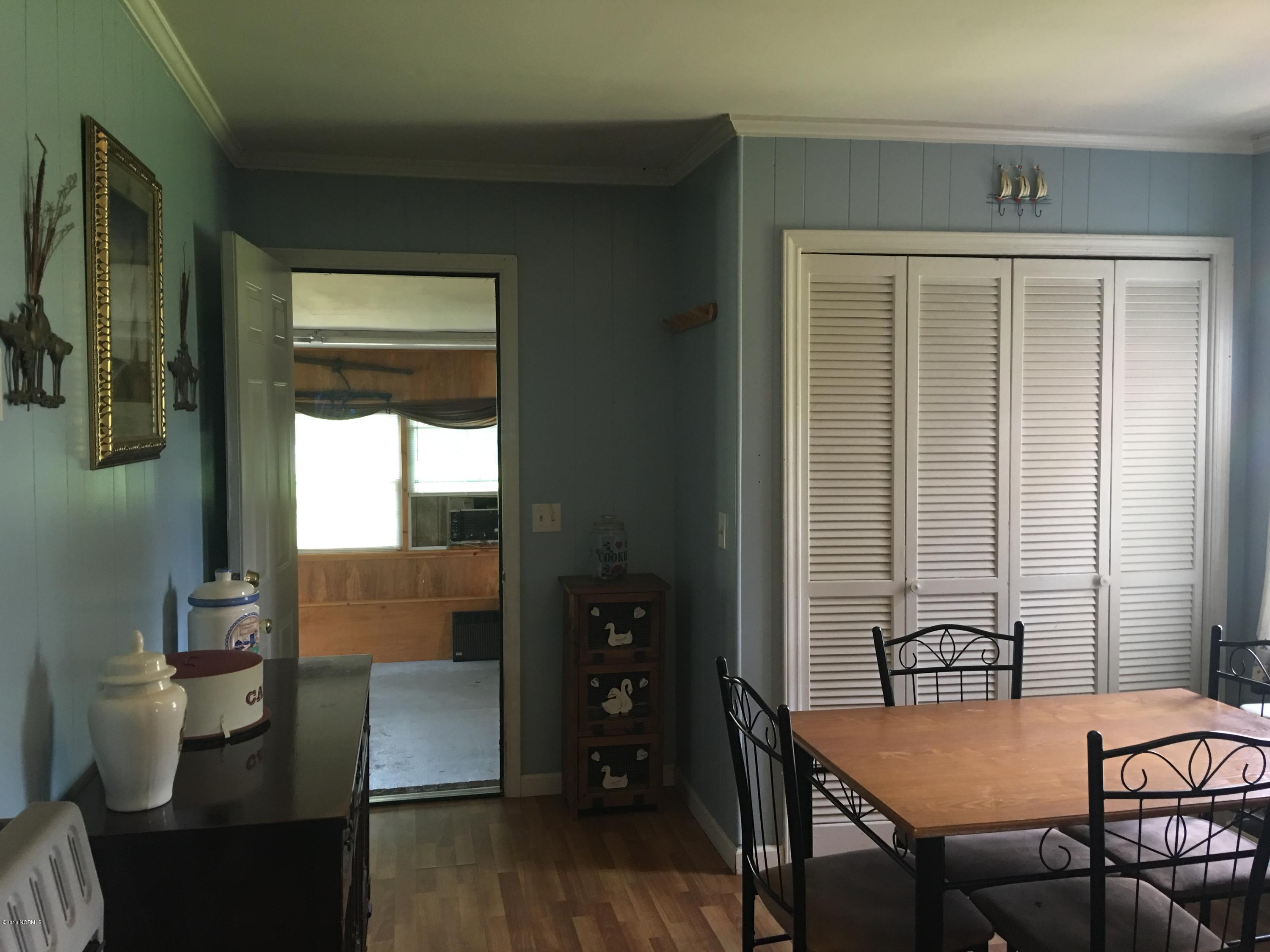 2165 Quarter Road Swanquarter, NC 27885 - Photo 7 of 16 Eat-in breakfast/dining area with full size laundry cleverly hidden behind the shutter doors.