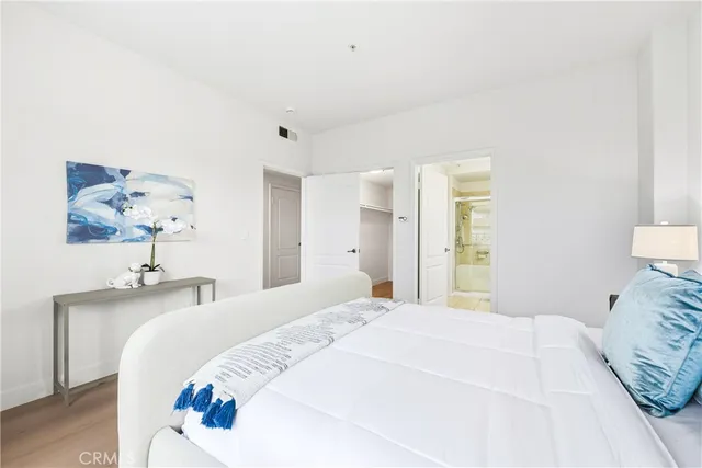 a bedroom with a bed and a lamp