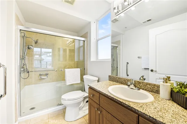a bathroom with a granite countertop sink toilet tub and shower