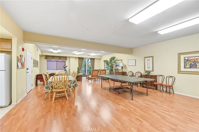 a dining room with furniture wooden floor a rug and a painting