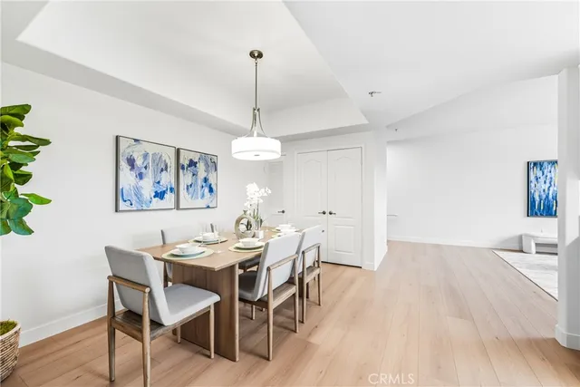 a view of a dining room with furniture wooden floor and chandelier