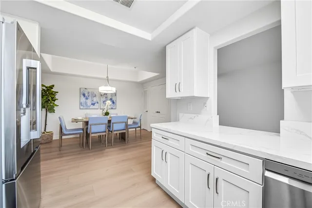 a kitchen with white cabinets and counter space