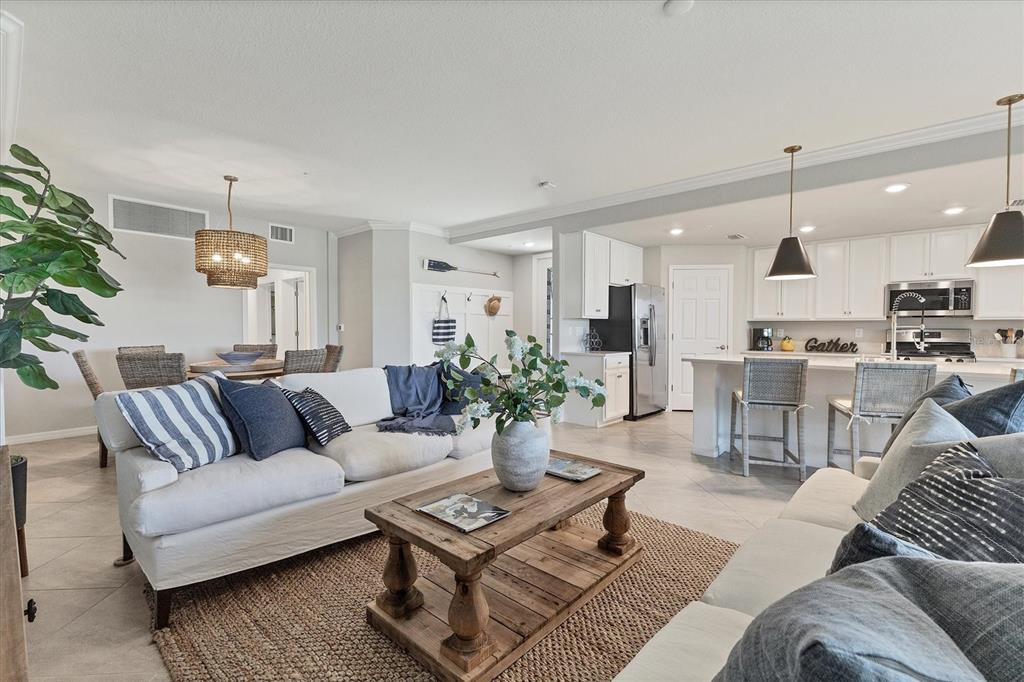 18113 Gawthrop Drive, Unit 101 Lakewood Ranch, FL 34211 - Photo 12 of 73 a living room with furniture kitchen view and a potted plant