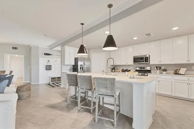 a kitchen with stainless steel appliances granite countertop white cabinets and stove