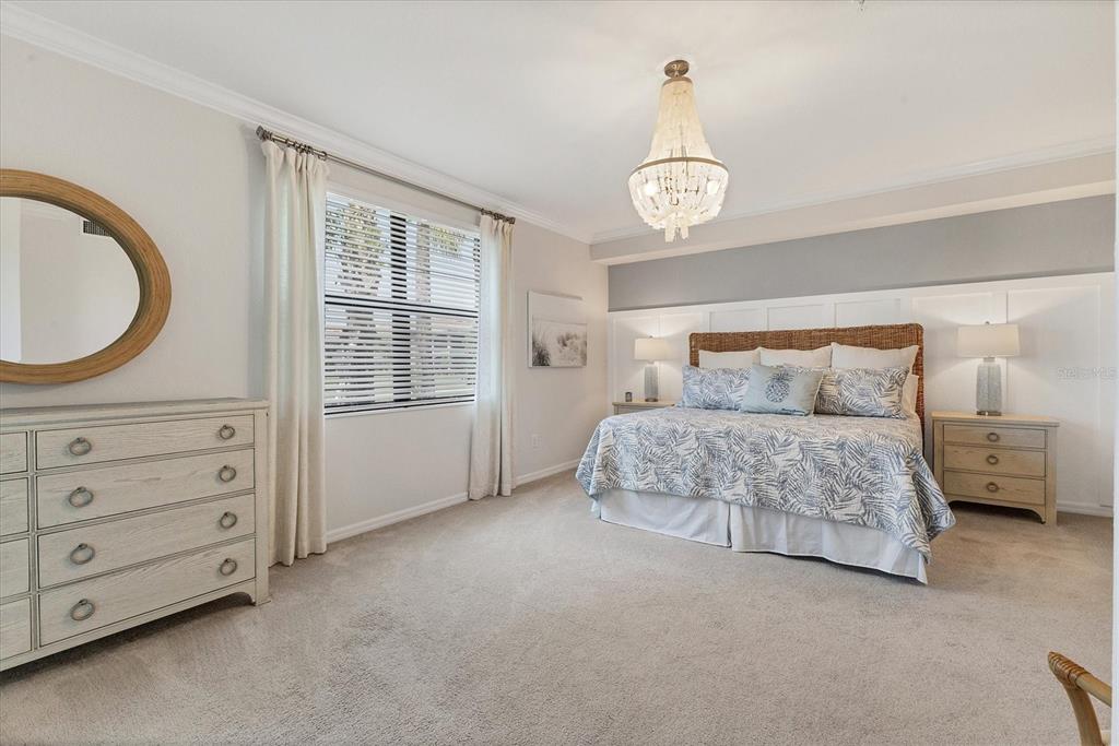 18113 Gawthrop Drive, Unit 101 Lakewood Ranch, FL 34211 - Photo 20 of 73 a bedroom with a bed a dresser and a window