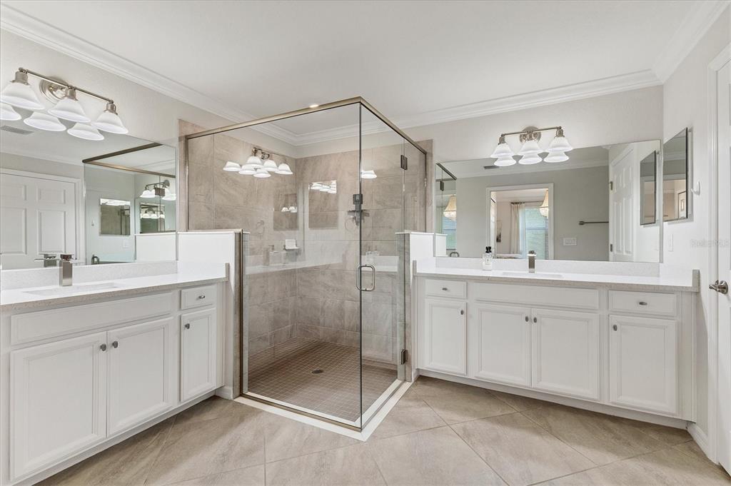 18113 Gawthrop Drive, Unit 101 Lakewood Ranch, FL 34211 - Photo 22 of 73 a spacious bathroom with a shower sink and a mirror