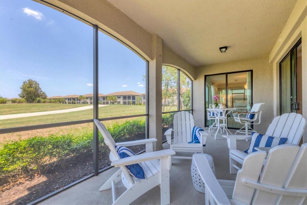 18113 Gawthrop Drive, Unit 101 Lakewood Ranch, FL 34211 - Photo 30 of 73 a view of a living room with furniture and floor to ceiling windows