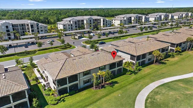 an aerial view of a house with swimming pool lawn chairs and a fire pit