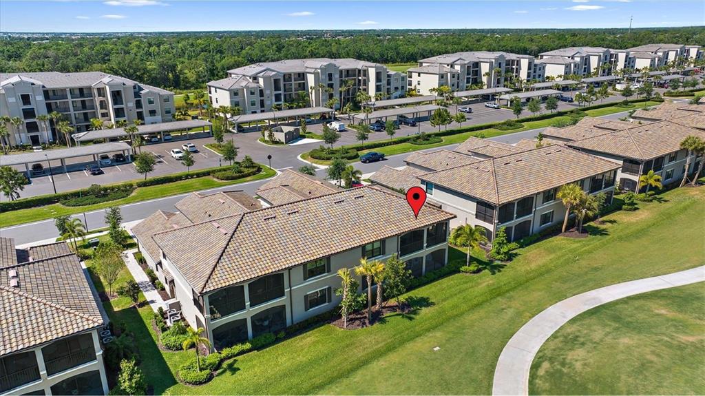 18113 Gawthrop Drive, Unit 101 Lakewood Ranch, FL 34211 - Photo 3 of 73 an aerial view of a house with swimming pool lawn chairs and a fire pit