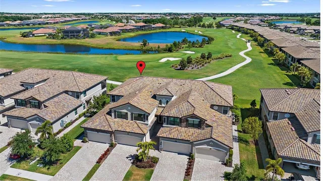 an aerial view of a house with outdoor space lake view