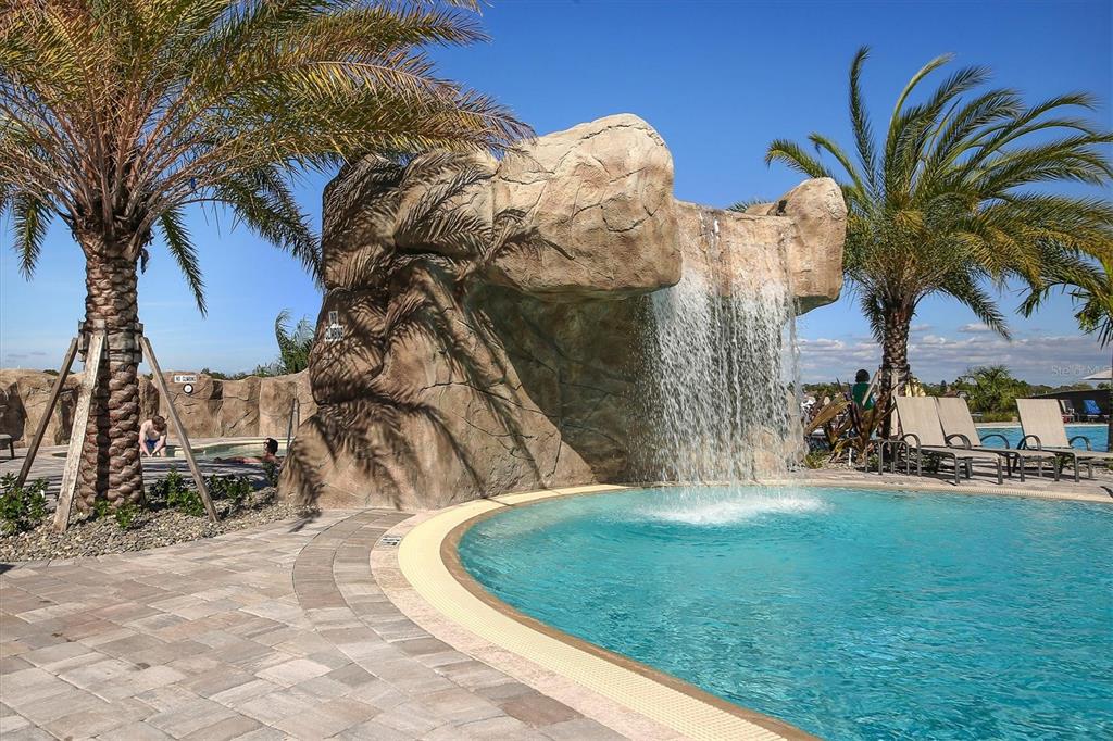 18113 Gawthrop Drive, Unit 101 Lakewood Ranch, FL 34211 - Photo 58 of 73 a backyard of a house with table and chairs