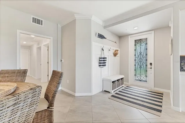 a living room with furniture a chandelier and a flat screen tv
