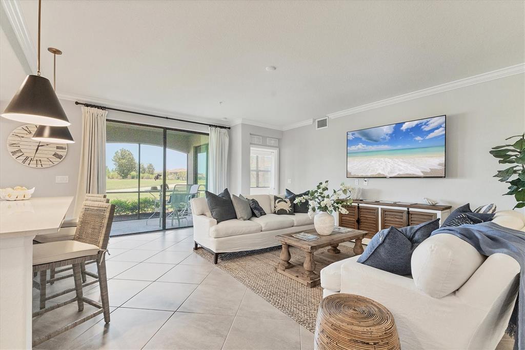 18113 Gawthrop Drive, Unit 101 Lakewood Ranch, FL 34211 - Photo 9 of 73 a living room with furniture and a large window