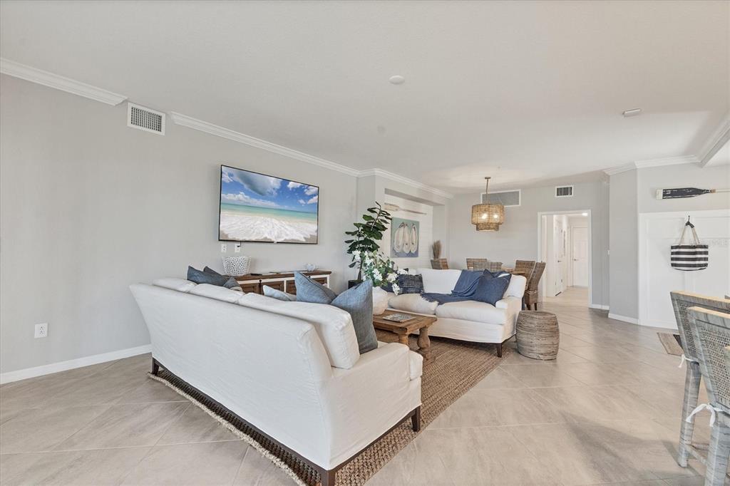 18113 Gawthrop Drive, Unit 101 Lakewood Ranch, FL 34211 - Photo 10 of 73 a living room with furniture and a flat screen tv