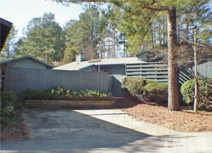 2754 Rue Sans Famille Raleigh, NC 27607 - Photo 1 of 5 a view of a entrance gate of the house and trees