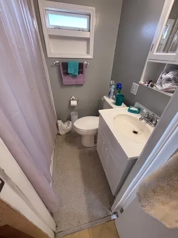 a white toilet sitting next to a bathroom sink