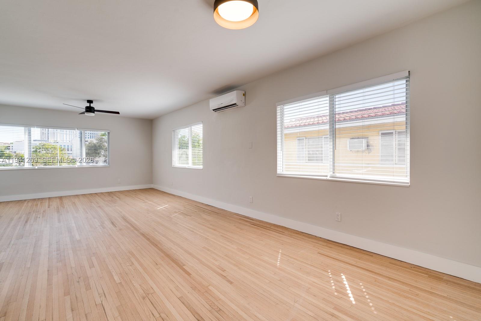 2922 South Le Jeune Road, Unit 2 Coral Gables, FL 33134 - Photo 2 of 16 a view of an empty room with wooden floor and window