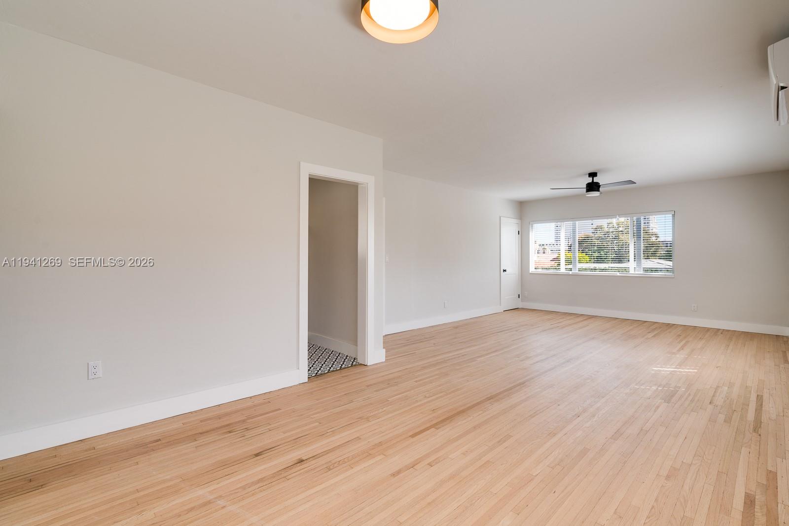 2922 South Le Jeune Road, Unit 2 Coral Gables, FL 33134 - Photo 5 of 17 an empty room with wooden floor and windows