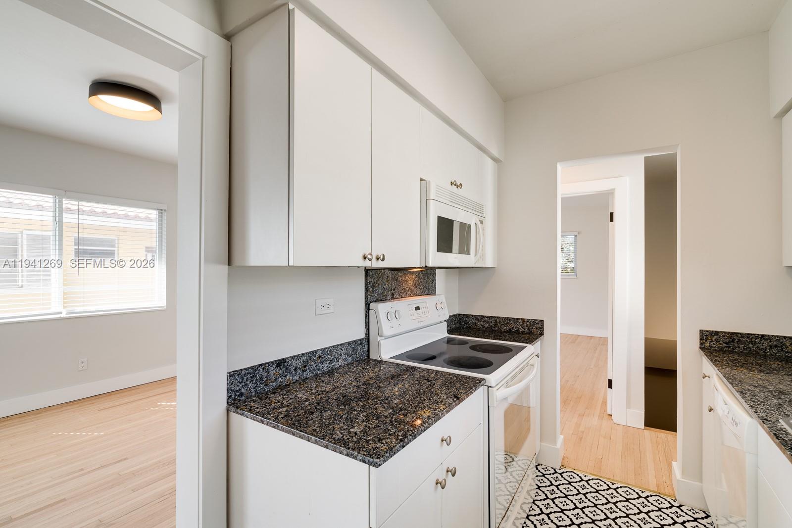 2922 South Le Jeune Road, Unit 2 Coral Gables, FL 33134 - Photo 8 of 17 a kitchen that has a sink and a stove in it