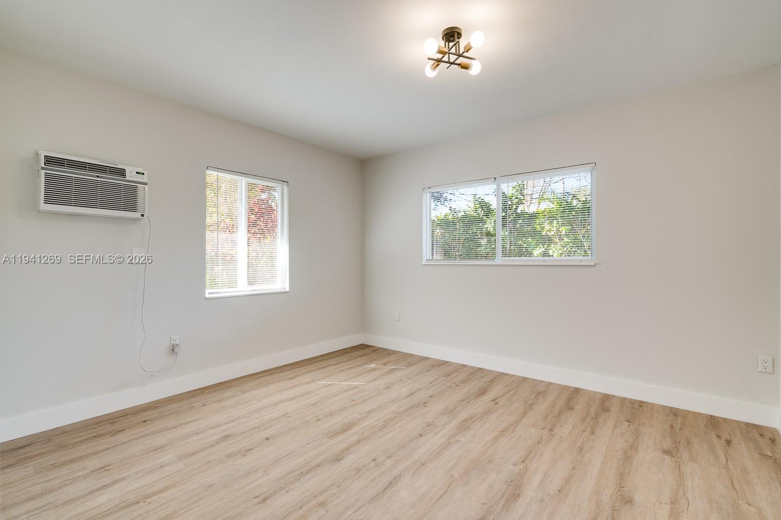 2922 South Le Jeune Road, Unit 2 Coral Gables, FL 33134 - Photo 9 of 16 a view of empty room with wooden floor and fan