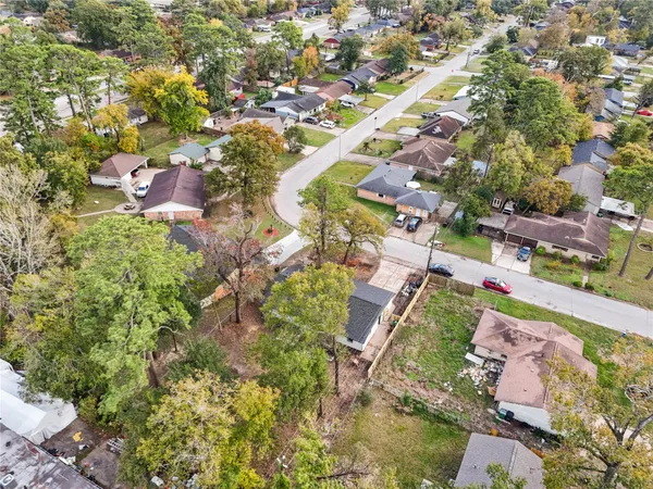 an aerial view of residential houses with outdoor space and street view