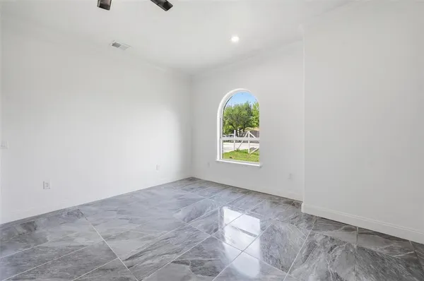 a view of an empty room with a fan