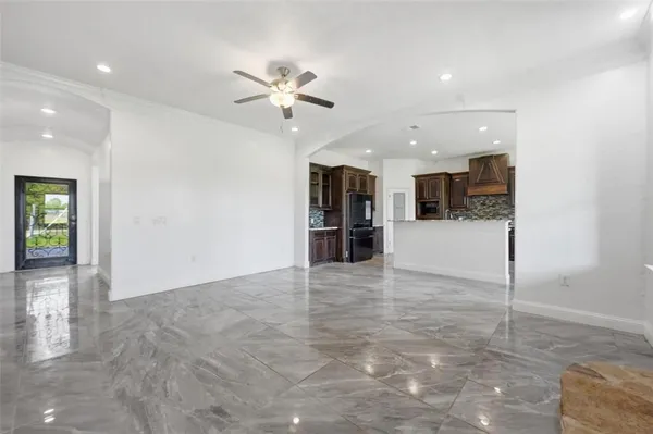 a kitchen with stainless steel appliances kitchen island granite countertop a table and chairs