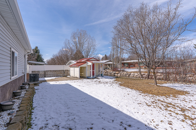 1045 Fox Farm Road Logan, UT 84321 - Photo 63 of 65 Yard covered in snow with a fenced backyard and a shed