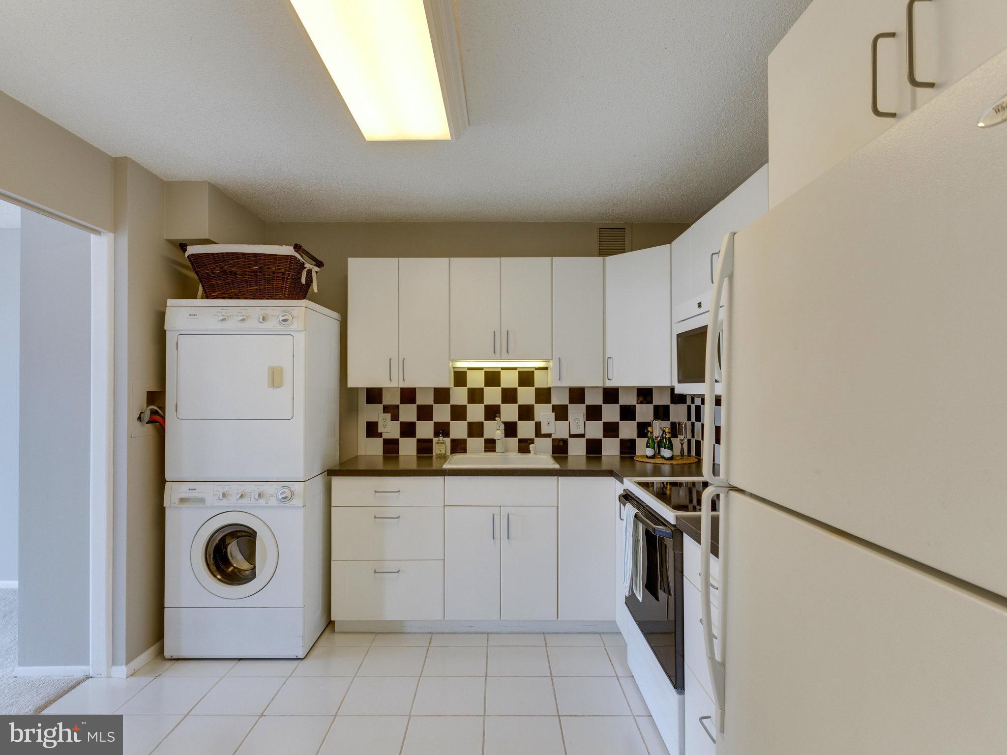 6800 Fleetwood Road, Unit 711 McLean, VA 22101 - Photo 3 of 27 a kitchen with a refrigerator and cabinets