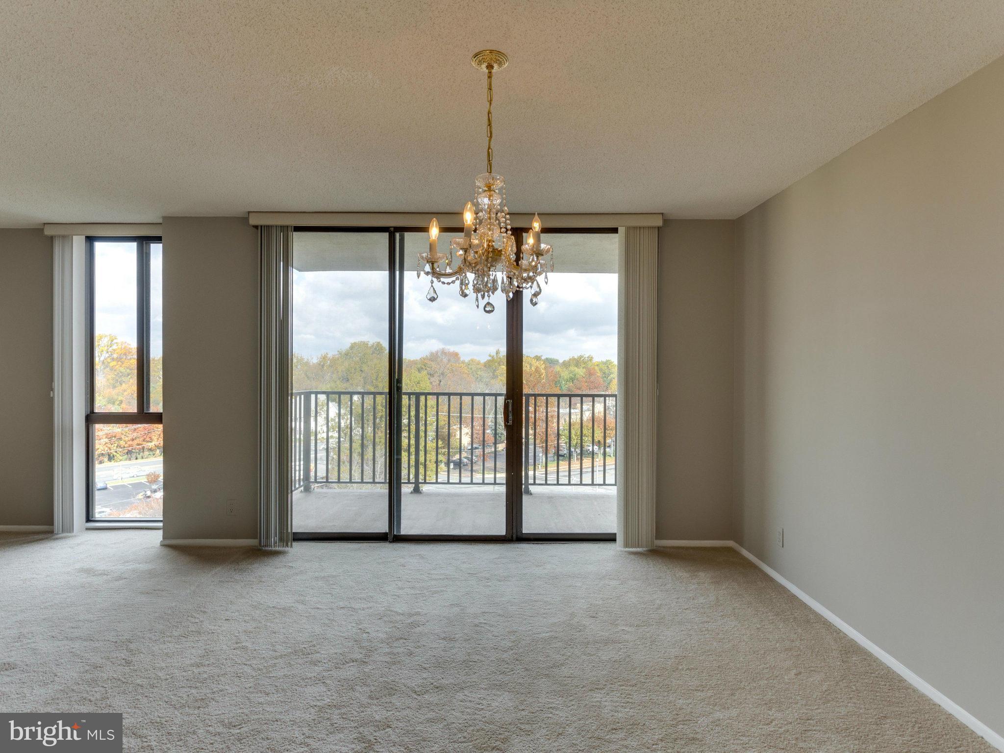 6800 Fleetwood Road, Unit 711 McLean, VA 22101 - Photo 9 of 27 a view of an empty room with windows and a balcony
