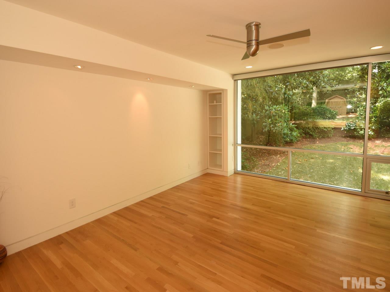 2109 St James Road Raleigh, NC 27607 - Photo 12 of 25 a view of empty room with wooden floor and fan
