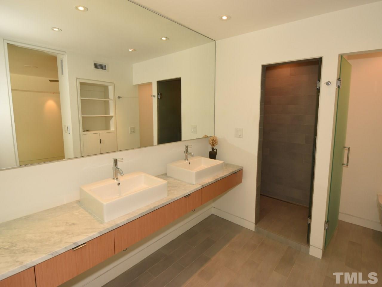 2109 St James Road Raleigh, NC 27607 - Photo 16 of 25 a bathroom with a double vanity sink and mirror