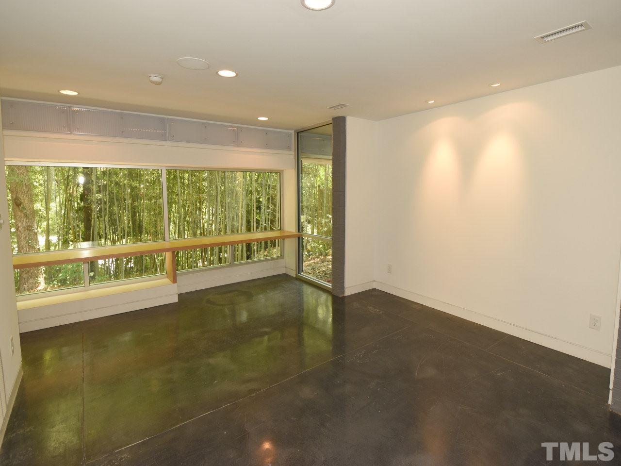 2109 St James Road Raleigh, NC 27607 - Photo 17 of 25 an empty room with wooden floor and windows