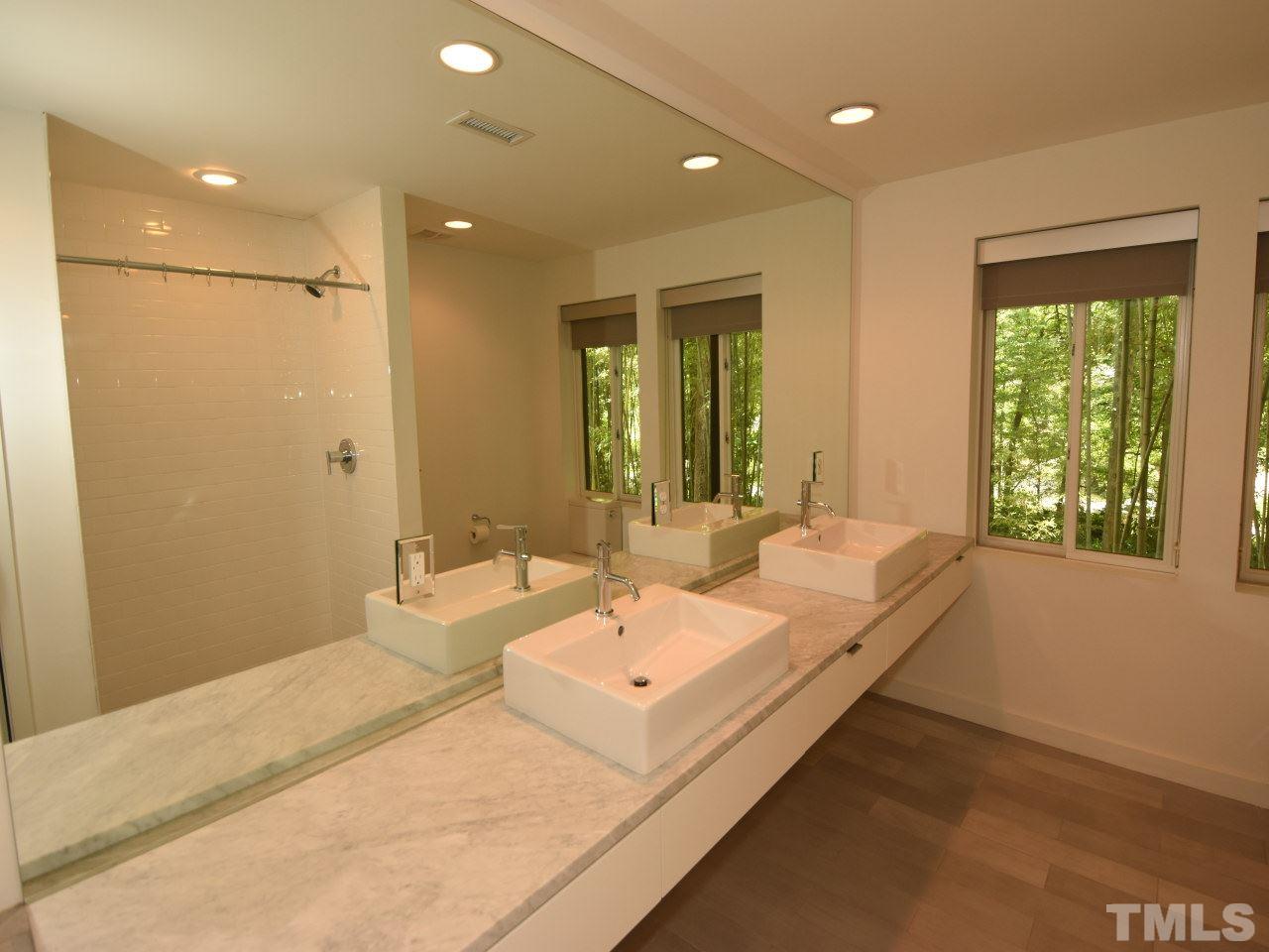2109 St James Road Raleigh, NC 27607 - Photo 23 of 25 a bathroom with a double vanity sink and a mirror
