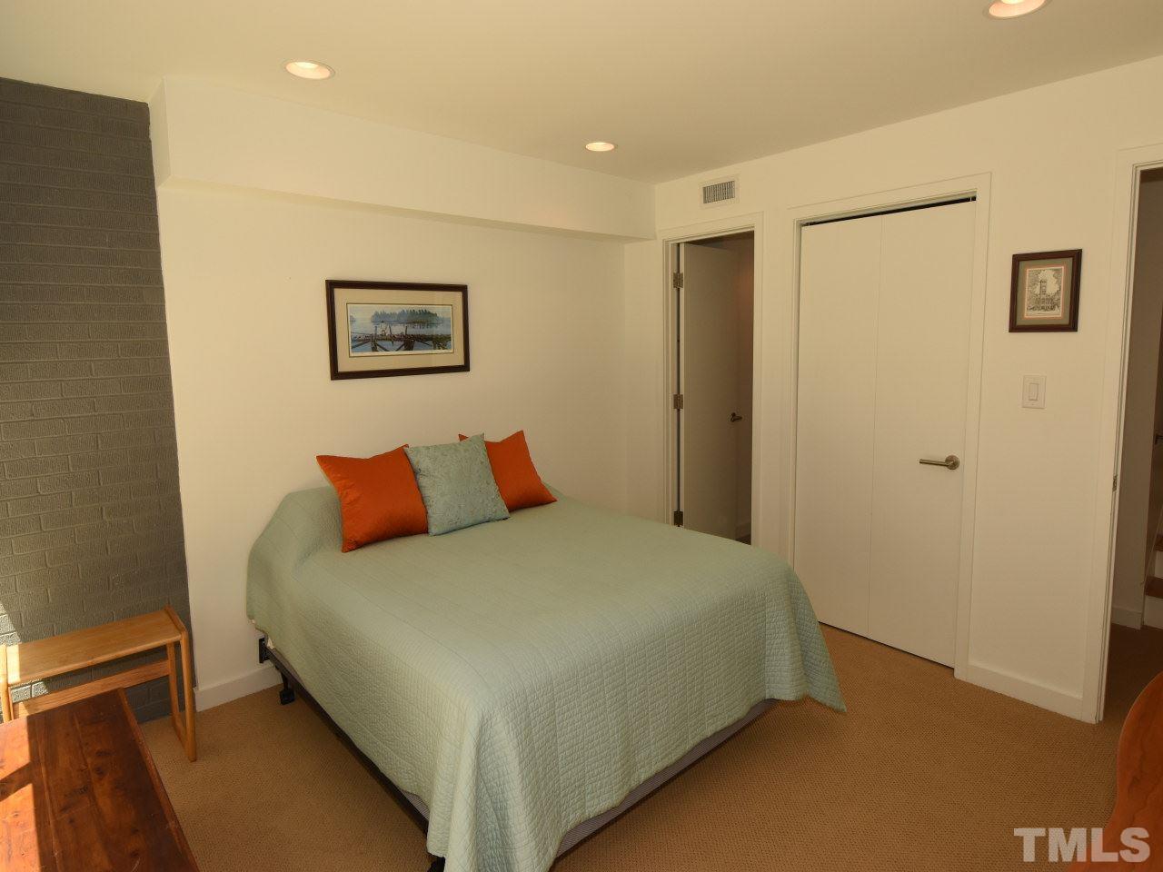 2109 St James Road Raleigh, NC 27607 - Photo 24 of 25 a bedroom with a bed and a wall painting