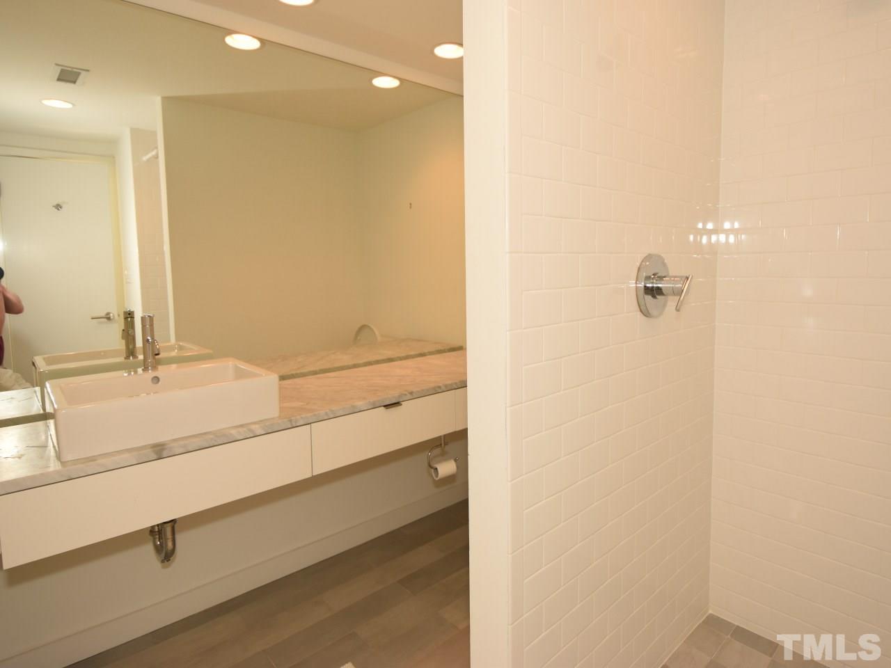 2109 St James Road Raleigh, NC 27607 - Photo 25 of 25 a bathroom with a double vanity sink and mirror
