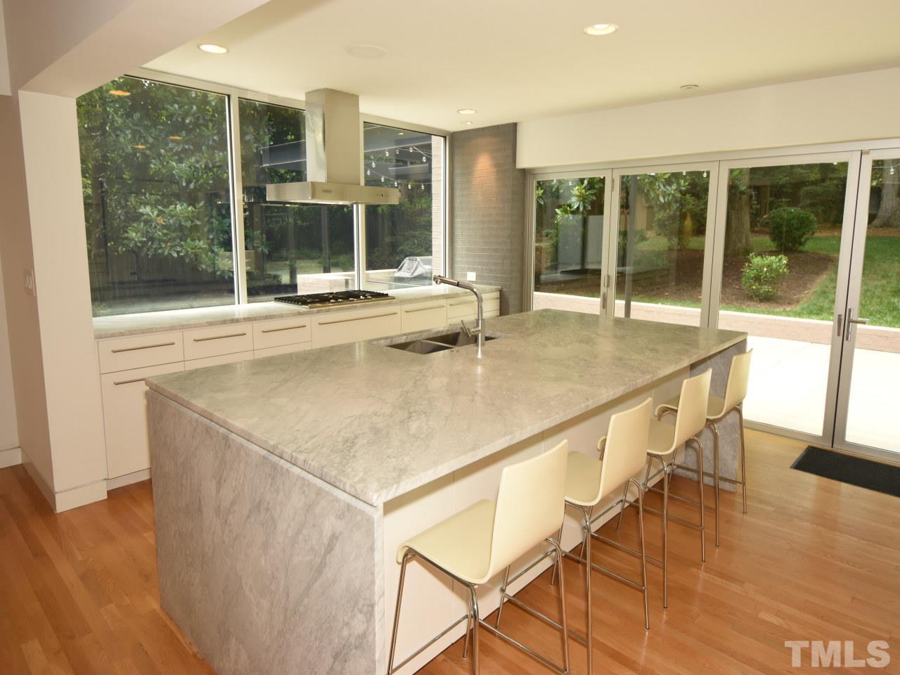 2109 St James Road Raleigh, NC 27607 - Photo 4 of 25 a kitchen with a sink and wooden floor
